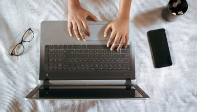Hands working on a laptop shot from above